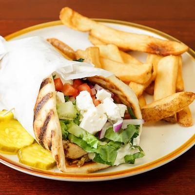 Chicken Souvlaki Pita, served with fries and pickles.