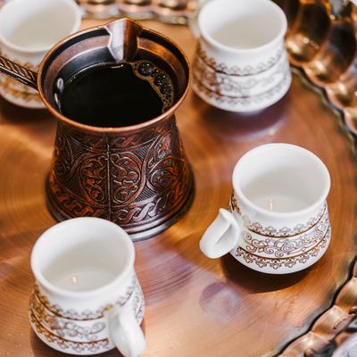 Turkish coffee set including a cezve pot and several small cups.