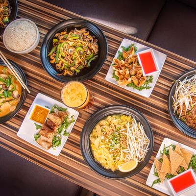 Assorted Asian dishes on a wooden table.