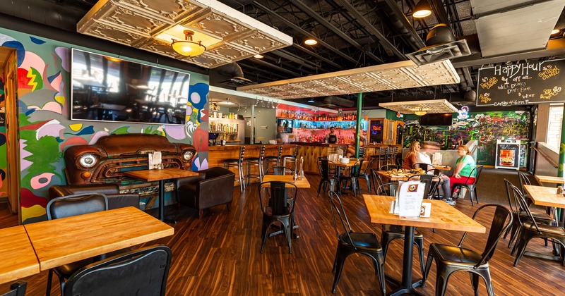 Interior, main seating area, bar, mural art on walls