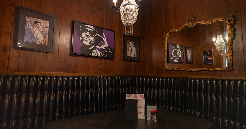 Interior, leather banquet seating with pictures on the wall