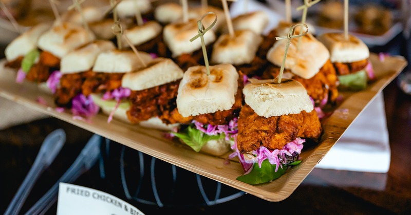 Tray of crispy chicken sliders topped with a red cabbage slaw