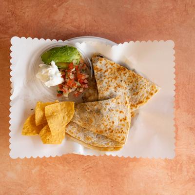 Quesadillas served with sour cream, avocado, and tomato salsa.
