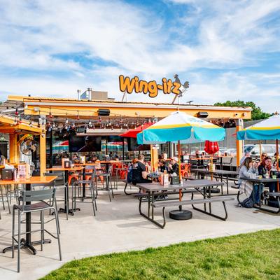 Exterior, wide view to patio, bar, sign.
