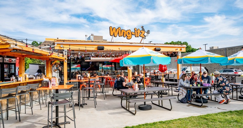 Exterior, wide view to patio, bar, sign