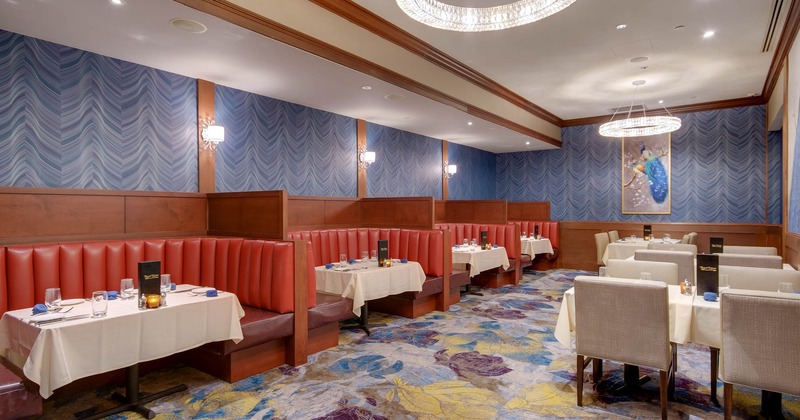 Interior, booth seating area on the left, tables and chairs