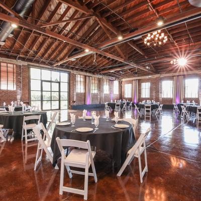 Banquette room with tables and chairs, featuring lots of natural and artificial light