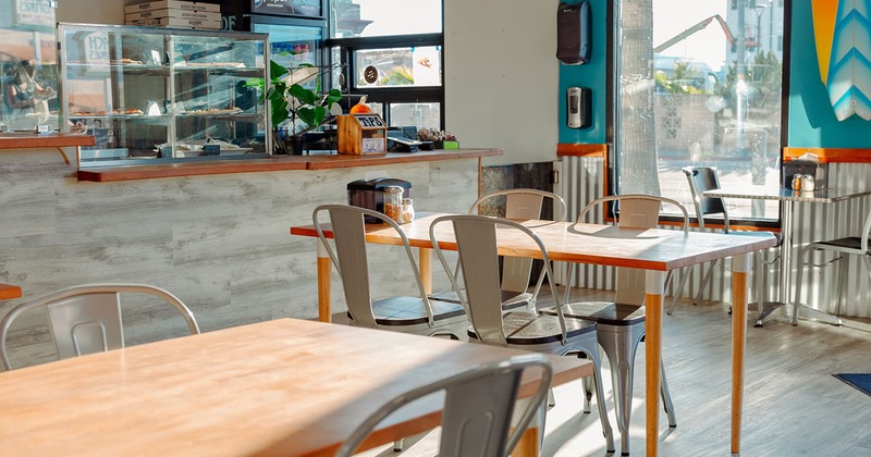 Interior, dining tables and glass display case at the order counter in the background