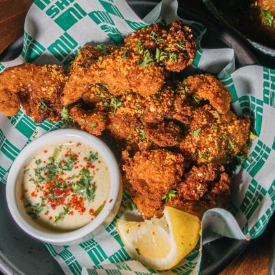 Fried bites paired with creamy sauce and lemon.