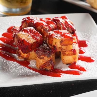 Wisconsin White Cheddar Cheese Curds covered in raspberry bourbon sauce and powdered sugar.