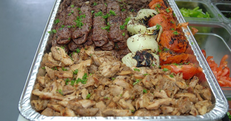 Assorted meats with grilled onions and tomatoes