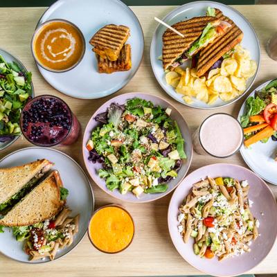 Assortment of menu items served on the table with drinks, overhead view.