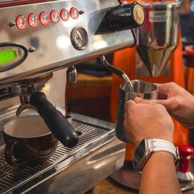 A barista frothing milk.