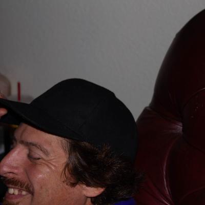 A guest with a hat, smiling.