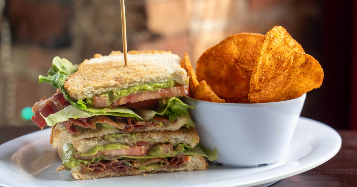 Avocado Bliss Sandwich served with a side of chips