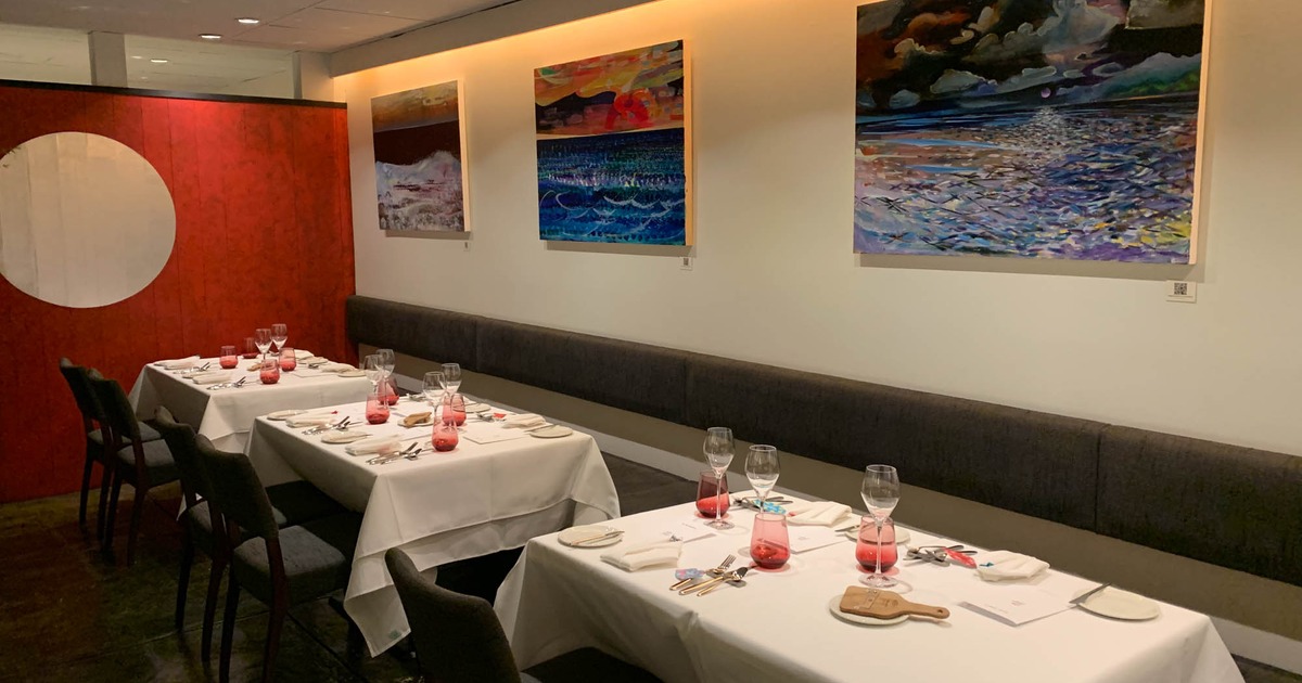 main room with many paintings of local artist friends at Margotto, the best truffle fine dining restaurant in Hawaii