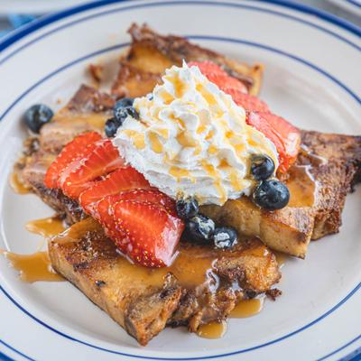 Bread Pudding, topped with berries and whipped cream.