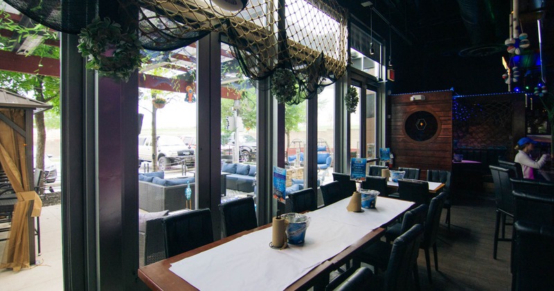 Interior, tables and chairs next to the windows