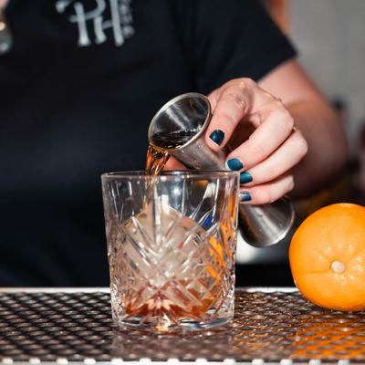Bartender pouring a cocktail.