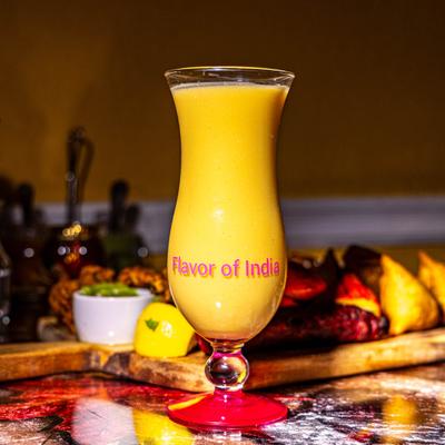 Mango milkshake served on the table with a mix grill platter.