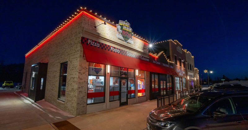 Exterior, amgle view to restaurant by night, entrance, sign above