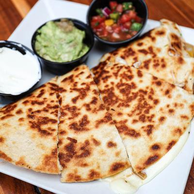 Quesadillas, served with salsa, guacamole, and sour cream.