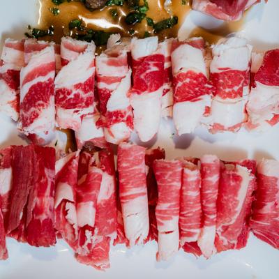 Raw beef slices arranged in neat rows.