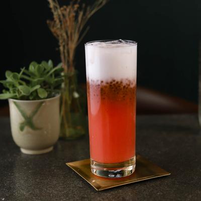 Guava Glow drink with a potted plant nearby.