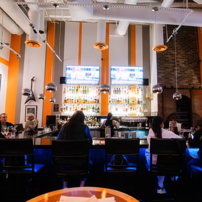 Customers sitting at the bar.