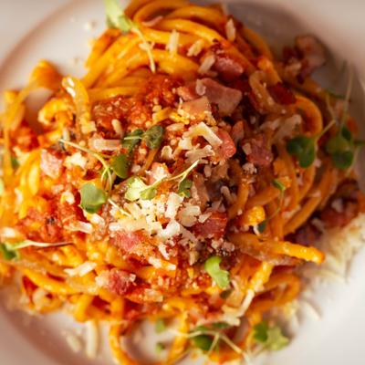 Spaghetti marinara topped with grated Parmesan cheese.