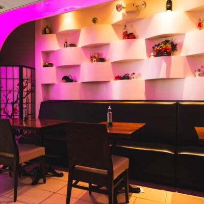 Interior, banquette seating by a decorated wall