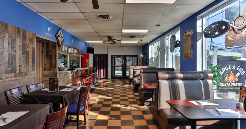 Interior seating area with tables, chairs and double booths