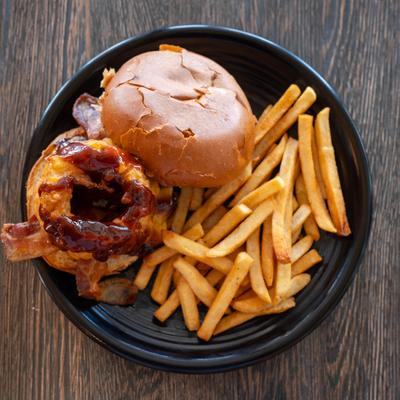 BBQ Burger topped with bacon and onion rings, served with fries.