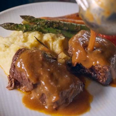 Braised Short Rib served over mashed potatoes, asparagus and carrots.