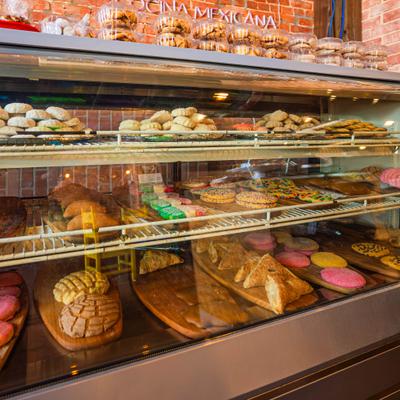 Bakery display case filled with pastries and breads.