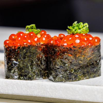 Salmon roe battleship sushi featuring salmon roe wrapped in nori seaweed.
