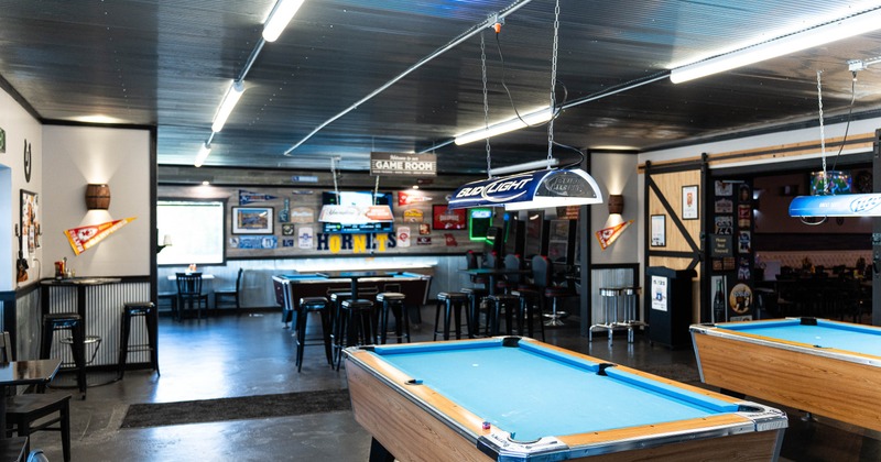Interior, pool tables with high chairs in the back