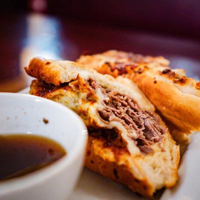 Italian beef sandwich and au jus sauce.