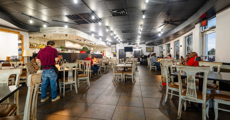 Interior, seating area with wooden white tables and chairs