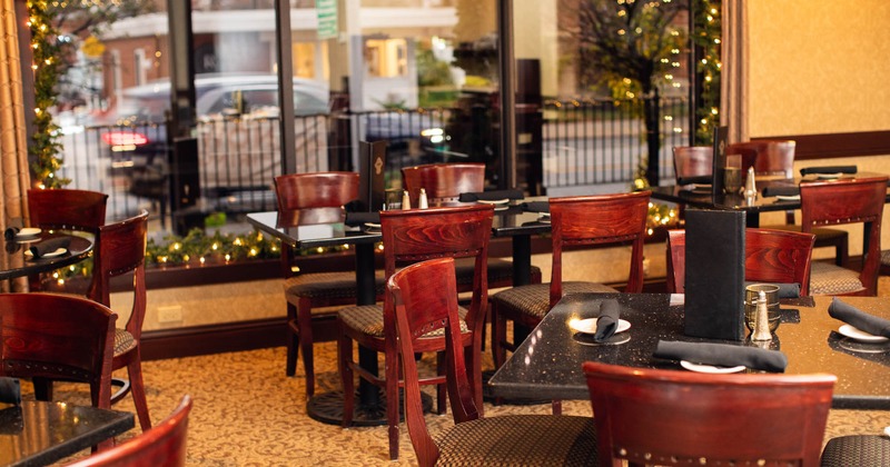 Interior, tables and chairs with tableware, ready for guests