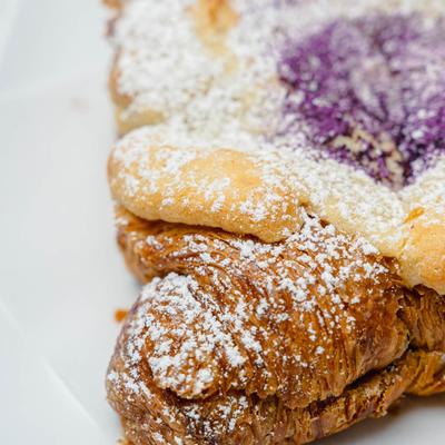 Pastry with powdered sugar and purple filling.