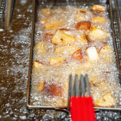 Potatoes frying in hot oil.