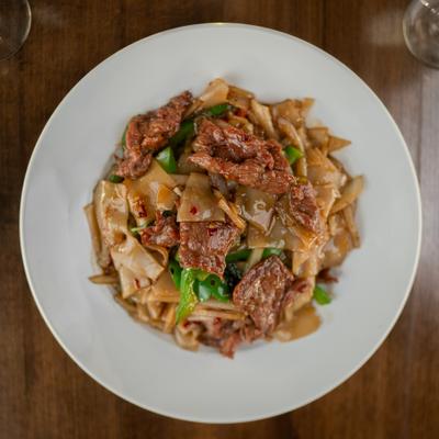 Overhead view of drunken noodles with beef and vegetables.