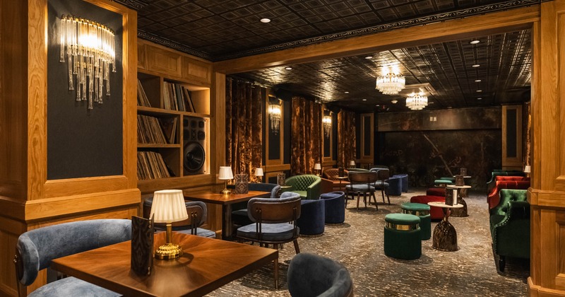 Elegant lounge with wooden paneling, vintage decor and colorful seating.