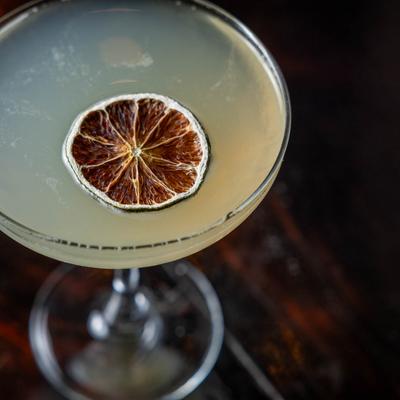 Coping Mechanism cocktail, garnished with dehydrated citrus wheel, top view.