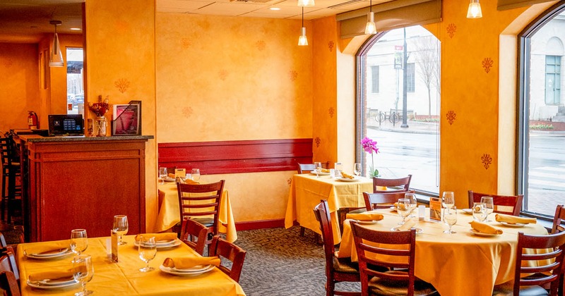 Interior, dining tables and chairs ready for guests