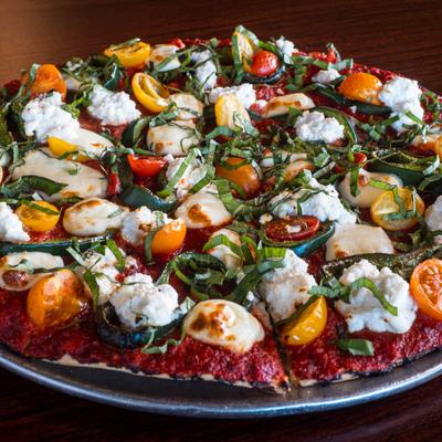 The Catania Pizza with fresh ricotta, poblano peppers, grape tomatoes, and basil.