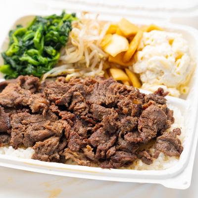 Grilled beef on rice, green spinach, bean sprouts, yams, and macaroni salad.