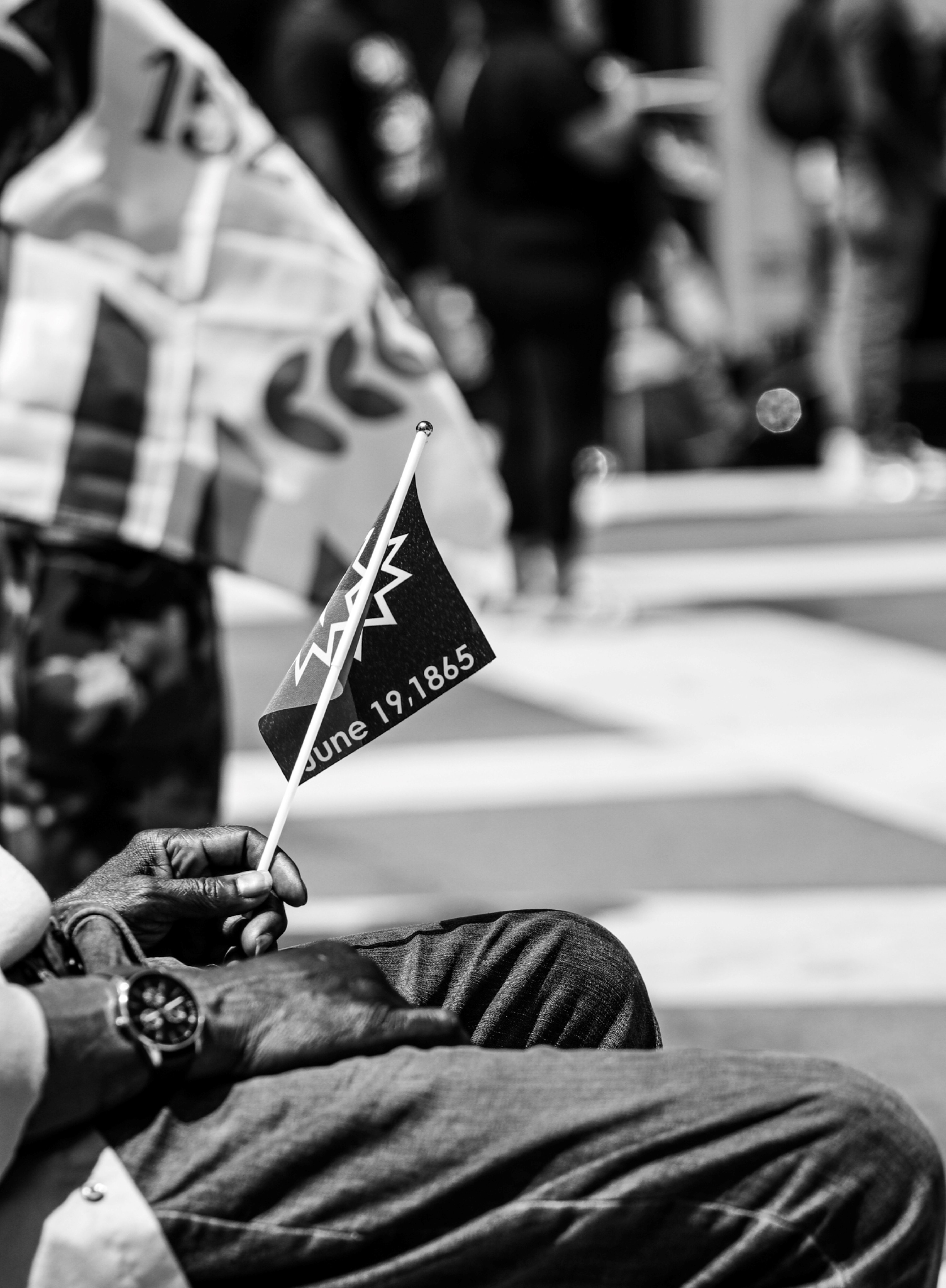Picture of parade attendee holding a memoriam flag for Juneteenth