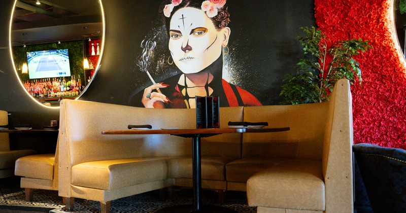 Interior seating area with 1/2 booth, traditional Mexican wall decoration